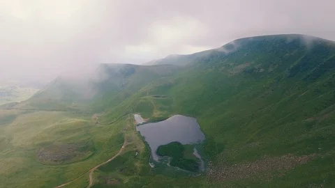 Aerial shot of a tiny square pond in the Carpathian Mountains in summer Stock Footage 93802761