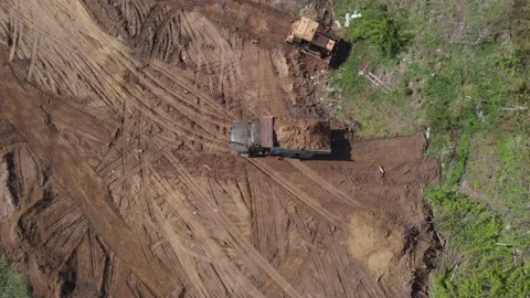 Aerial shot of tipper unloading ground on further construction site. Stock Footage 130219830
