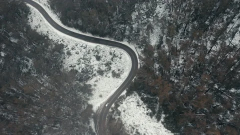 Aerial shot top down view of car driving in snow forest at Falls Creek Stock Footage 157394554