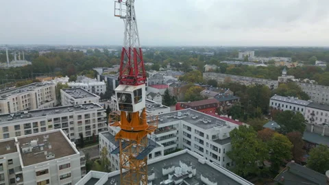 Aerial shot of a tower crane with a rotating mechanism on top. Stock Footage 287986116
