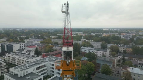 Aerial shot of a tower crane with a rotating mechanism on top. Stock Footage 287986889