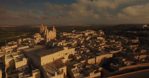 Aerial shot tracking back over Mdina during Sunset Stock Footage 73473619