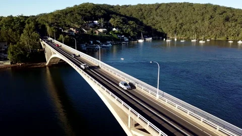 Aerial shot tracking over bridge, water and bush Australia Stock Footage 136644053