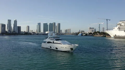 Aerial shot tracking yacht in harbour of downtown Miami Stock Footage