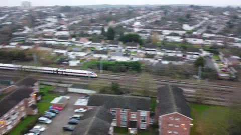 Aerial Shot of Train Passing through Suburbs Stock Footage 135416072