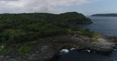 Aerial shot of a tropical island with rocky coast Stock Footage