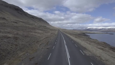 Aerial shot of Two cyclists on an empty road in Iceland Stock-Footage 98142733