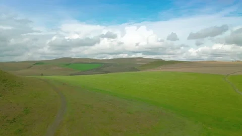 Aerial Shot of Undulating Grass Slope Country Path Yellow Green Meadow Inner Stock Footage 337979232