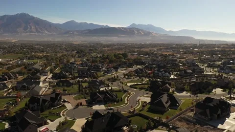 Aerial shot with upper class suburban neighborhood in valley with mountains Stock Footage 130667287