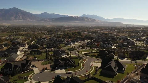 Aerial shot with upper class suburban neighborhood in valley with mountains Stock Footage 146923950