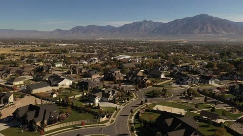 Aerial shot with upper class suburban neighborhood in valley with mountains Stock Footage 146924743