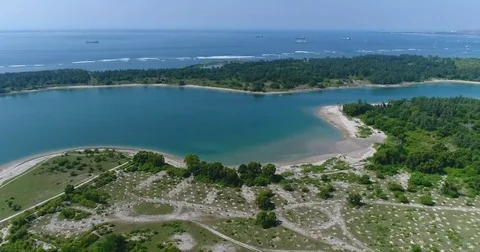 Aerial shot of the various bays and beaches within Serangan island Stock Footage