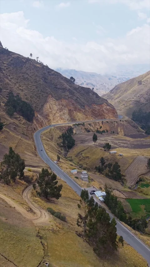 Aerial shot in vertical format capturing red vehicle navigating serpentine 스톡 동영상 308418744