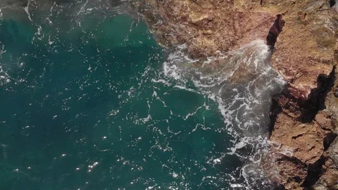 Aerial shot. Vertical plan down. the waves are splashing blue and turquoise in Stock Footage 103846640