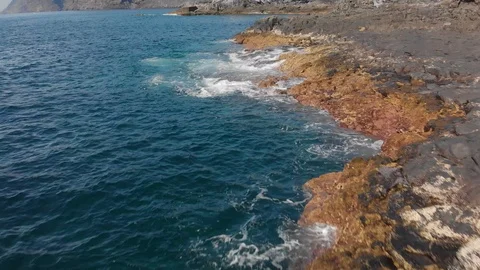 Aerial shot. Vertical plan down. the waves are splashing blue and turquoise in Stock Footage 104029569