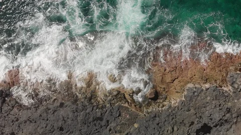 Aerial shot. Vertical plan pull down. The blue and turquoise ocean and sea Stock Footage 104030450