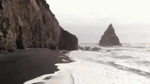 Aerial shot of Volcanic Sea Stack On Reynisfjara Beach In Iceland Stock Footage 126664575