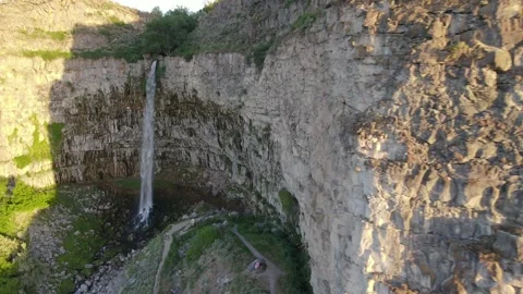 Aerial Shot, waterfall down large canyon wall. Video stock 169546281