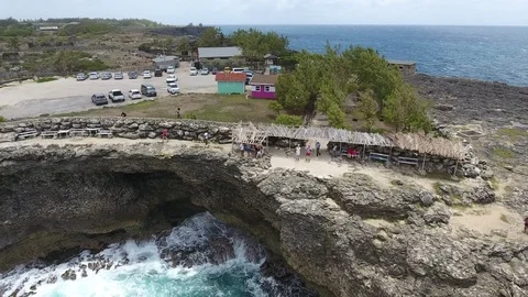 Aerial shot of waves and cliff face zoom out Stock Footage 88567086