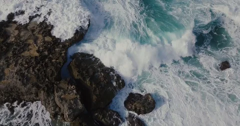 Aerial shot of waves cascading ocean rock in Hawaii Stock Footage