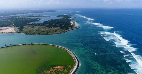 Aerial shot of waves over shallow reef and turquoise water Stock Footage 79780703
