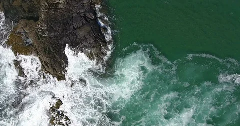 Aerial Shot of waves on rocks Stock Footage 106848311