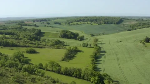 Aerial shot of wheat fields and green hills, Gers, France Stock Footage 344247473