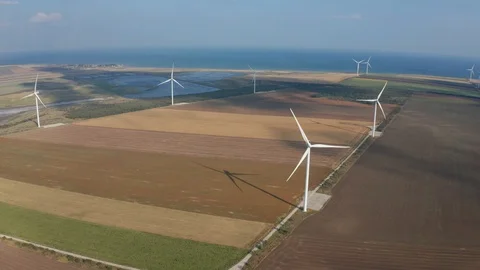 Aerial shot of wind generators among arable land Video stock 124152135