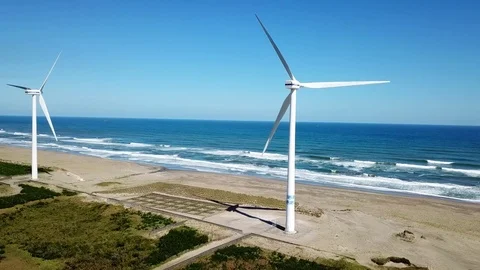 Aerial shot of  wind power generator on the beach Stock Footage 81263265