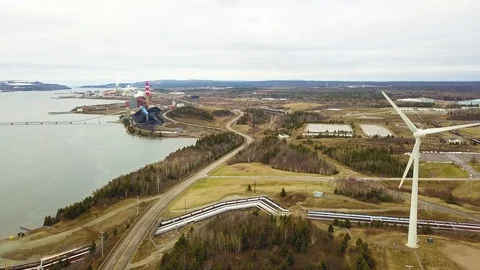 Aerial shot of windmill &amp; coal power plant during winter, Nova Scotia, Canada Stock Footage 102247604