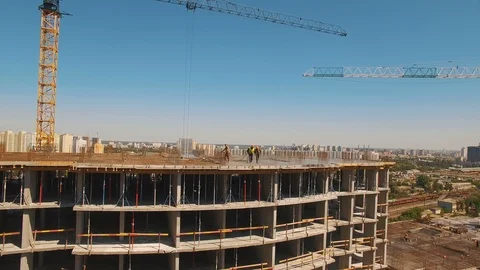 Aerial shot of workers in a construction, structure in the process to be build Stock Footage 91893705
