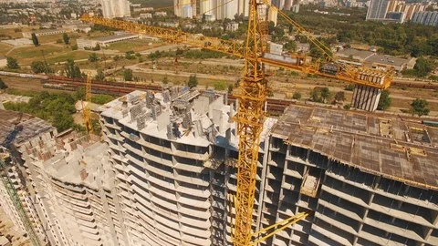 Aerial shot of workers in a construction, structure in the process to be build Stock Footage 92995617