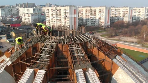 Aerial shot of workers in a construction, structure in the process to be build Stock Footage 142885888