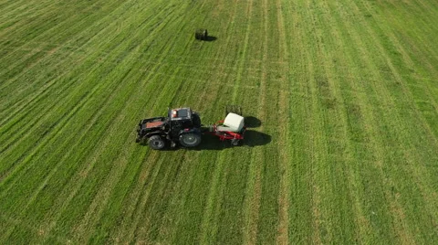 Aerial Shot of Working Tractor with Bale Lifter on Agricultural Field at Bright  Video stock 65246777