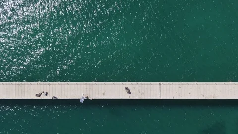 Aerial shots, top down view of Rapid Bay Jetty. Some shots contain fisherman. Video stock 104584117