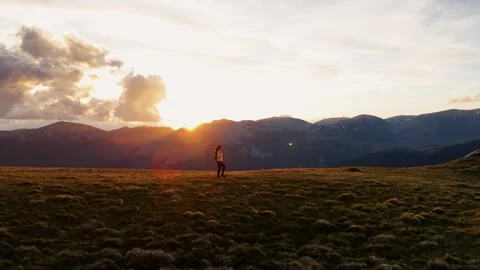 Aerial side drone view of young woman hiker walking on a hill Stock Footage 276678048