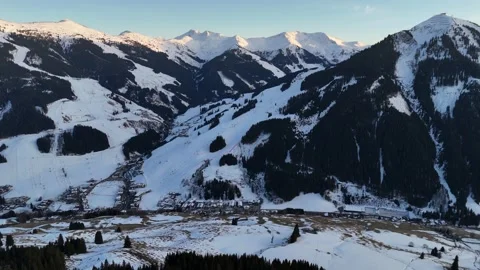 Aerial side fly right over snowy mountains, Saalbach, 4K 60fps Description Stock Footage 329902918