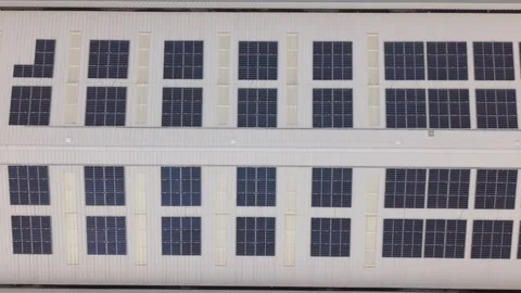 Aerial Side Flyover Rooftop Solar Panels on Industrial Building Stock-Footage 334006787