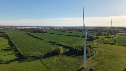 Aerial side forward drone flight past wind turbines over countryside Stock Footage 333935996