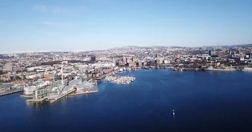 Aerial side moving shot of Aker Brygge and Akershus in Oslo, Norway Stock Footage 85866795