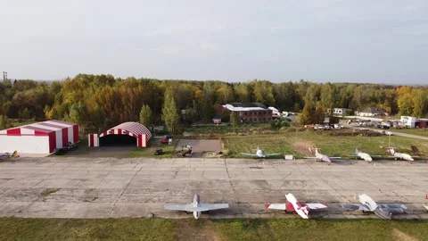 Aerial side orbit around rural airport and planes Video stock 333625381