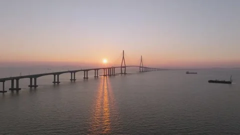 Aerial Side Pass Along Incheon Bridge's Long Shadow at Sunset Stock Footage 344694370