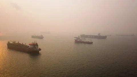 Aerial side scrolling shot of hazy sunrise vessel anchorage , Singapore Stock Footage 118603056