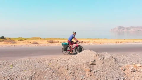 Aerial side tracking view young fit caucasian male cyclist cycle fully load.. Stock Footage 233117307