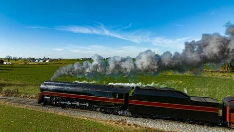 Aerial Side View of an Antique Streamlined Steam Locomotive Running By Blowing B Stock Photos