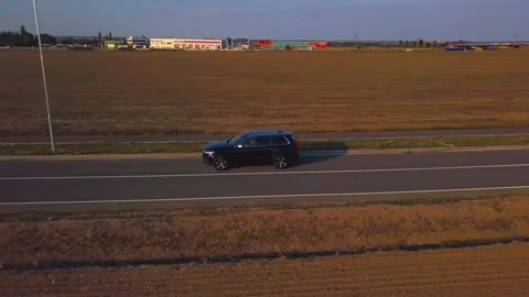 Aerial side view of a car on road Stock Footage 153327587