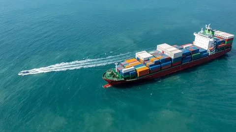 Aerial side view of cargo ship carrying container and running with pilot bo.. Stock Photos