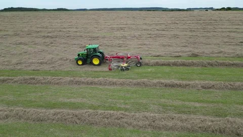 Aerial side view of John Deere tractor working in a field Stock Footage 276963402