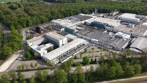 Aerial side view of large industrial factory with logistics activity Stock Footage 334026990
