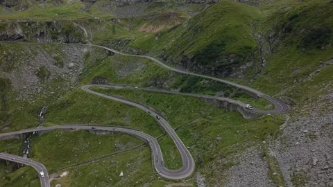 Aerial side view of layered Transfăgărășan mountain road with moving traffic Stock Footage 340823271